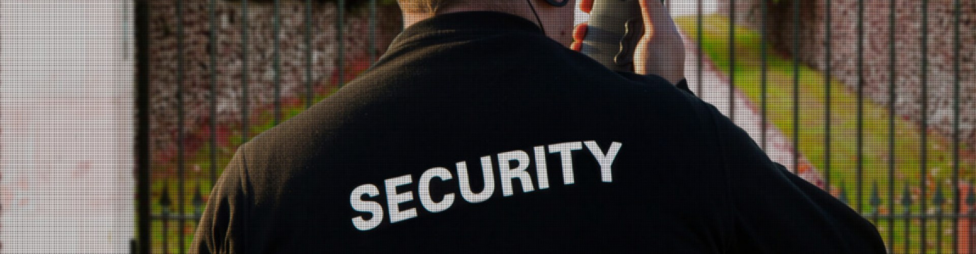 Security Guard near fence with radio