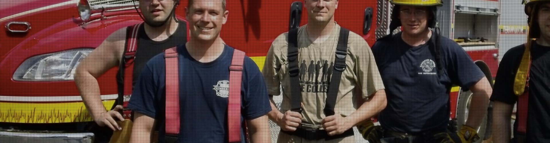 Firefighters standing near a firetruck